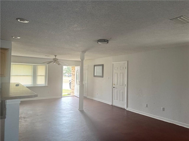 unfurnished room featuring ceiling fan and a textured ceiling