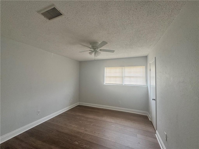 unfurnished room with ceiling fan, dark hardwood / wood-style flooring, and a textured ceiling