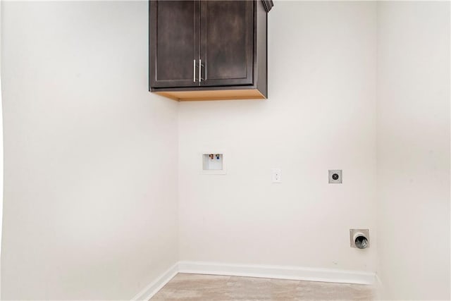 washroom featuring hookup for a washing machine, electric dryer hookup, cabinets, and light hardwood / wood-style floors