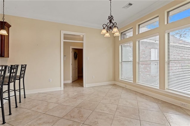 dining room with light tile patterned flooring, crown molding, and an inviting chandelier