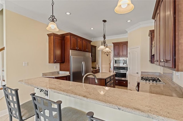 kitchen with sink, built in appliances, kitchen peninsula, and decorative light fixtures