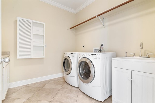 clothes washing area featuring crown molding, sink, separate washer and dryer, and light tile patterned flooring