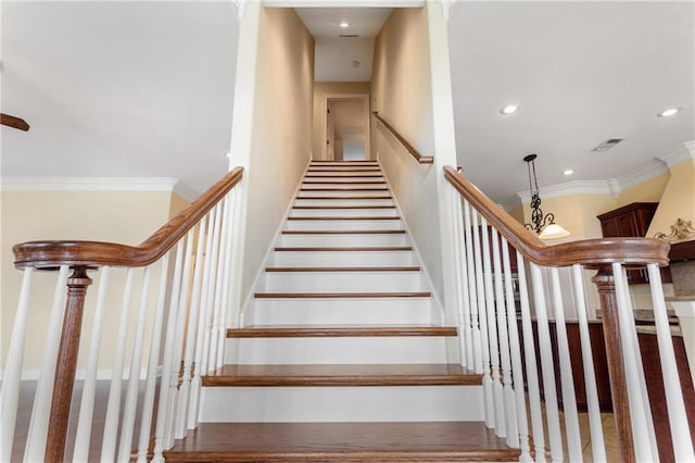 staircase featuring crown molding