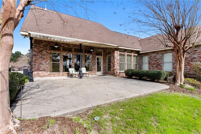 rear view of property with a patio and a yard