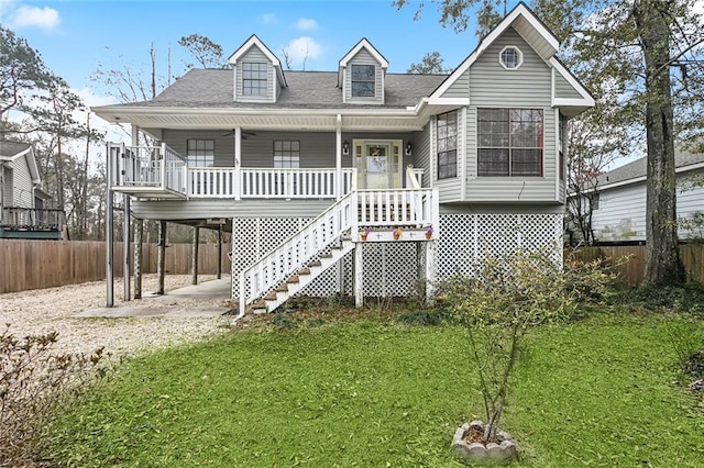 rear view of house with a yard, a carport, and covered porch