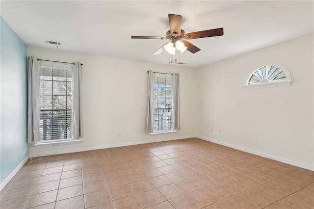 empty room with light tile patterned floors and ceiling fan