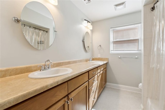 bathroom featuring tile patterned flooring, vanity, and toilet