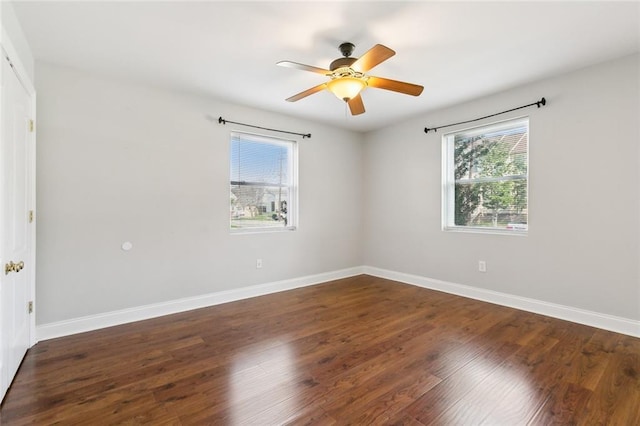 spare room with dark hardwood / wood-style floors and ceiling fan