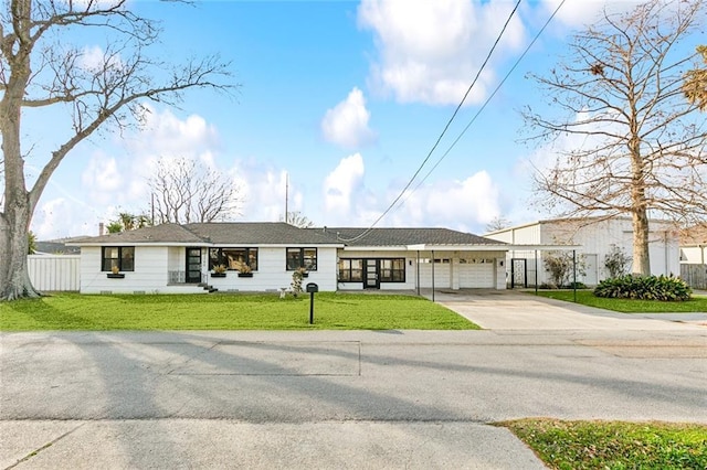 ranch-style house featuring a garage and a front yard