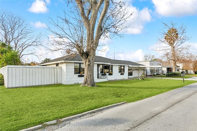 ranch-style house with a garage and a front yard