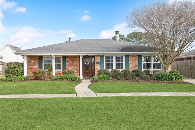 single story home featuring a front lawn