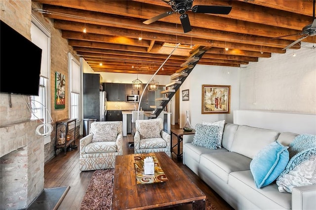 living room with dark wood-type flooring, ceiling fan, and beam ceiling