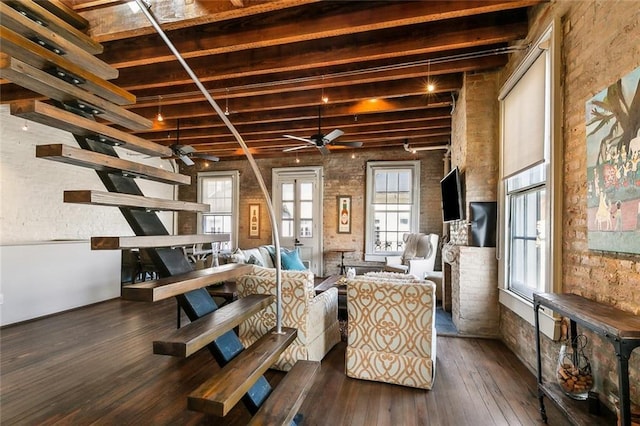 interior space with dark hardwood / wood-style flooring, beam ceiling, plenty of natural light, and ceiling fan