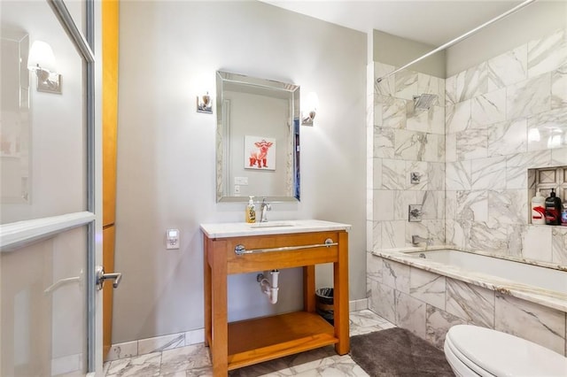 full bathroom featuring tiled shower / bath combo, vanity, and toilet