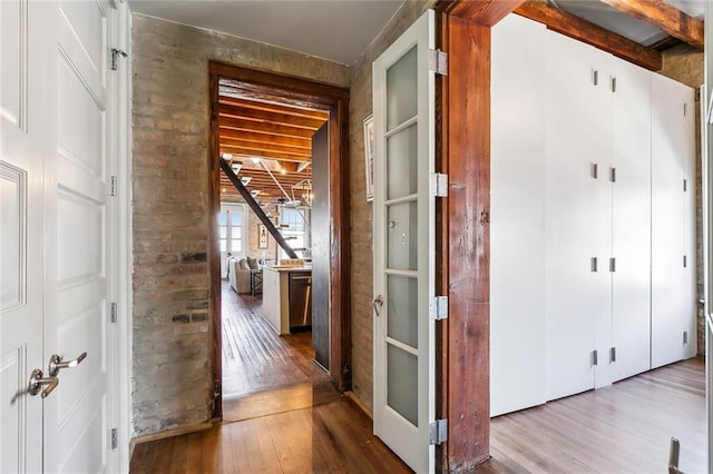 hallway with hardwood / wood-style floors