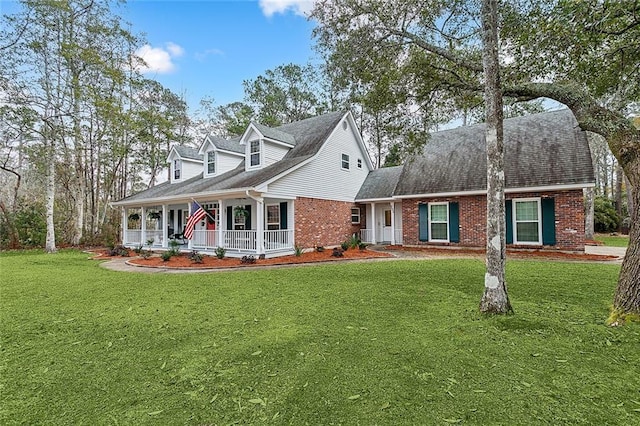 new england style home with a porch and a front lawn