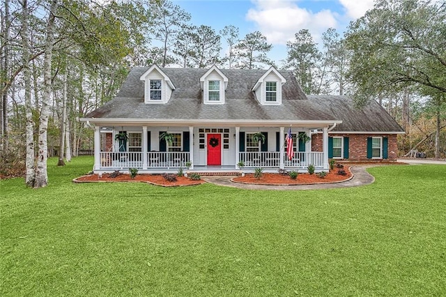 cape cod home featuring covered porch, brick siding, and a front lawn
