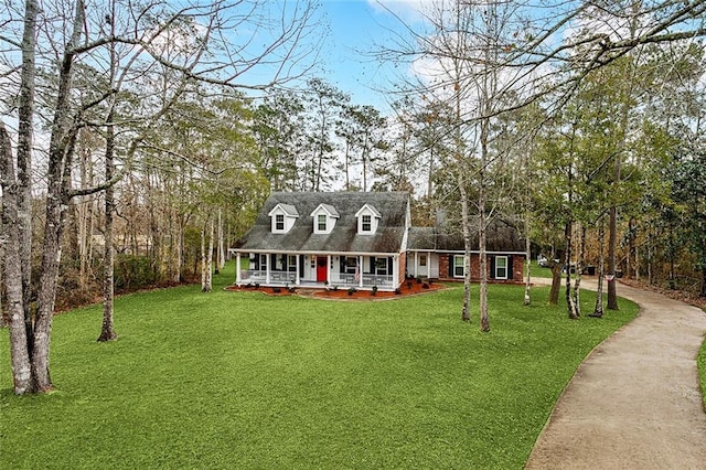 cape cod-style house with a front lawn and covered porch