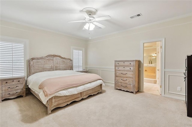 bedroom featuring ornamental molding, a decorative wall, visible vents, and light colored carpet