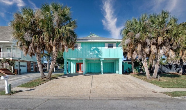 raised beach house with a carport and a garage