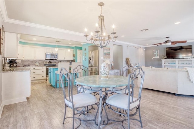 dining space featuring crown molding, ceiling fan with notable chandelier, and light wood-type flooring