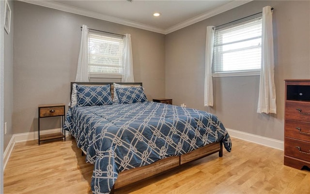 bedroom with ornamental molding and light wood-type flooring