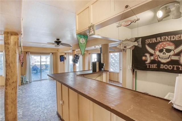 kitchen with ceiling fan and ornate columns