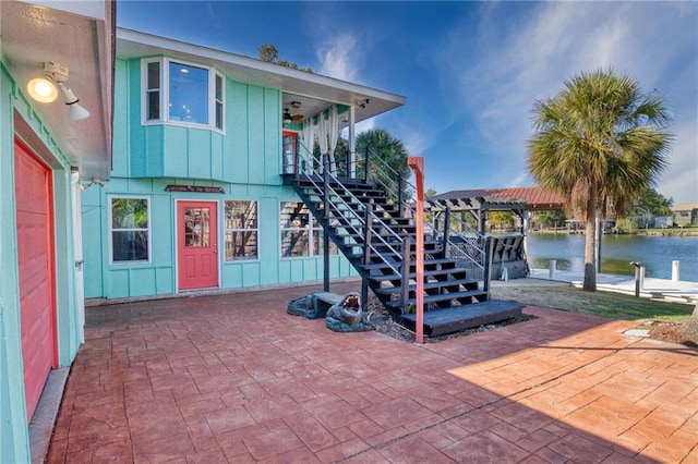 view of patio / terrace with a pergola and a water view