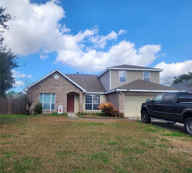 view of front facade with a garage and a front lawn