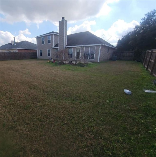 rear view of house with a yard