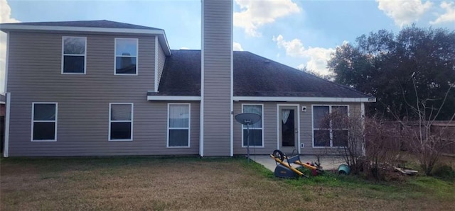 rear view of property featuring a yard and a patio