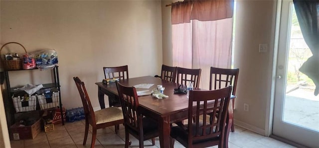 tiled dining space with a wealth of natural light