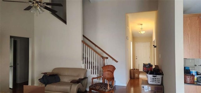 living area featuring hardwood / wood-style flooring and ceiling fan