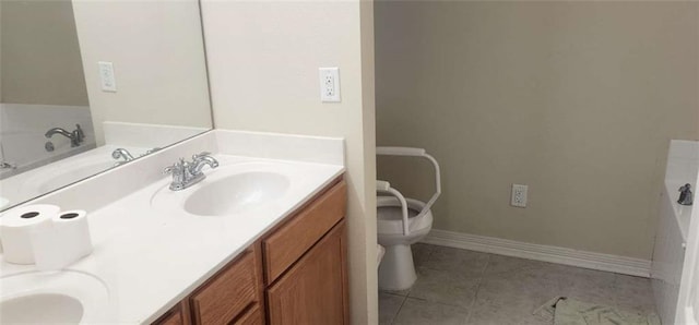 bathroom featuring vanity, a tub to relax in, tile patterned flooring, and toilet