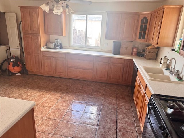 kitchen featuring sink, ceiling fan, and black appliances