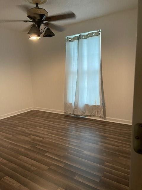 spare room featuring ceiling fan and dark hardwood / wood-style flooring