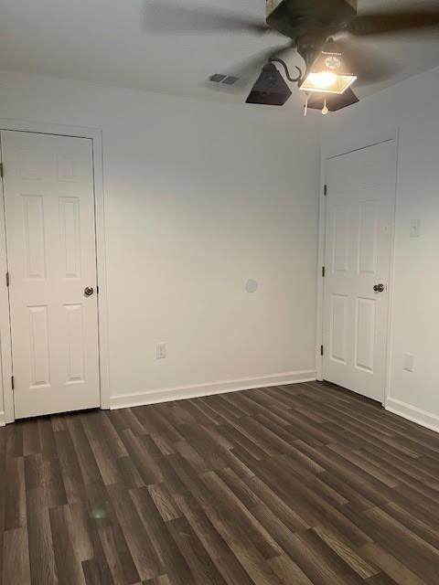 unfurnished room with ceiling fan and dark hardwood / wood-style floors