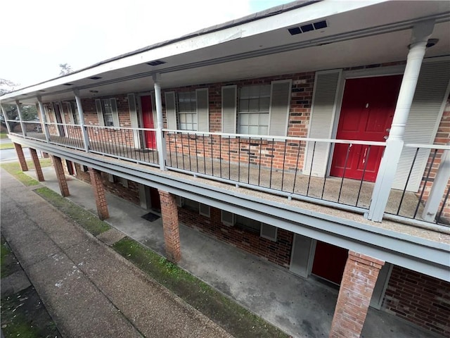 332022 Kabel Dr, New Orleans, LA 70131 - view of side of home featuring brick siding and covered porch