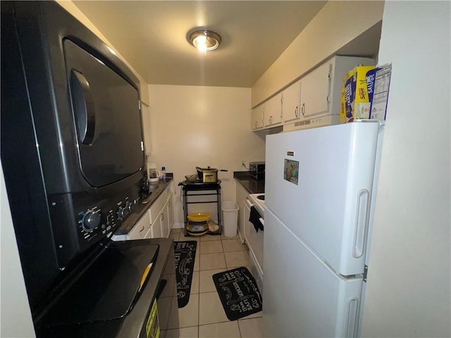 332022 Kabel Dr, New Orleans, LA 70131 - kitchen featuring freestanding refrigerator, light tile patterned floors, and white cabinets