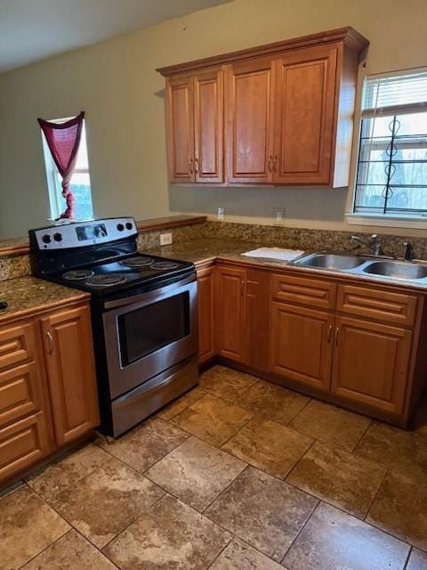 kitchen featuring sink and stainless steel range with electric stovetop