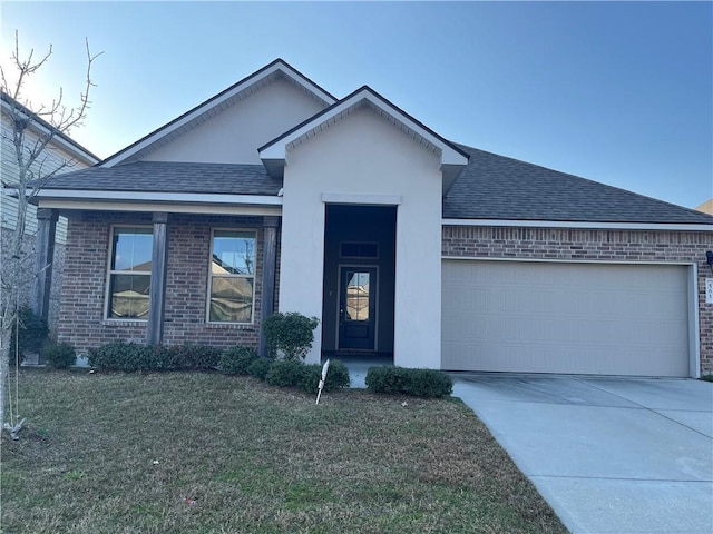 view of front of home featuring a garage and a front lawn