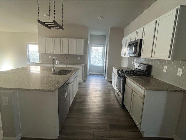 kitchen with white cabinetry, sink, decorative backsplash, and appliances with stainless steel finishes