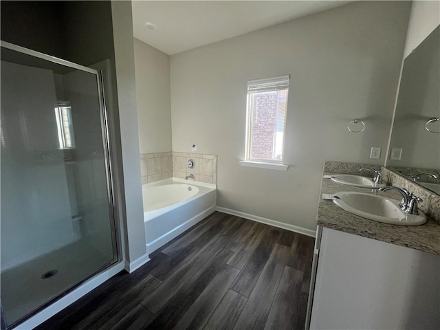 bathroom with vanity, independent shower and bath, and hardwood / wood-style floors