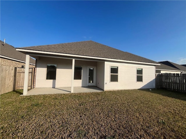 rear view of house with a yard and a patio area