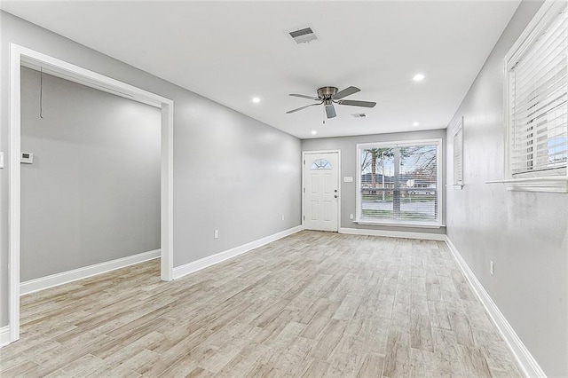 spare room with ceiling fan and light wood-type flooring