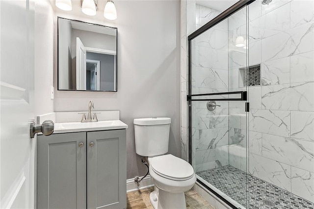 bathroom featuring vanity, toilet, an enclosed shower, and wood-type flooring