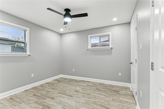 spare room with ceiling fan and light wood-type flooring