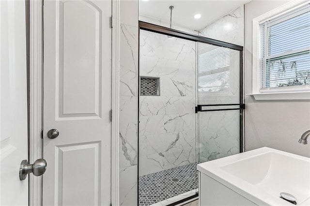 bathroom featuring sink and a shower with door