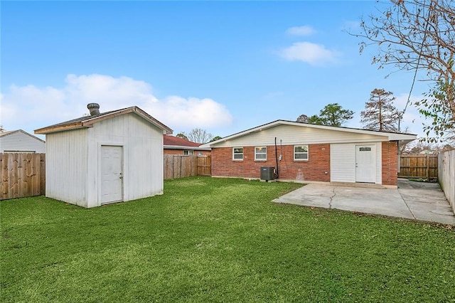 rear view of house featuring a shed, central AC unit, a patio area, and a lawn