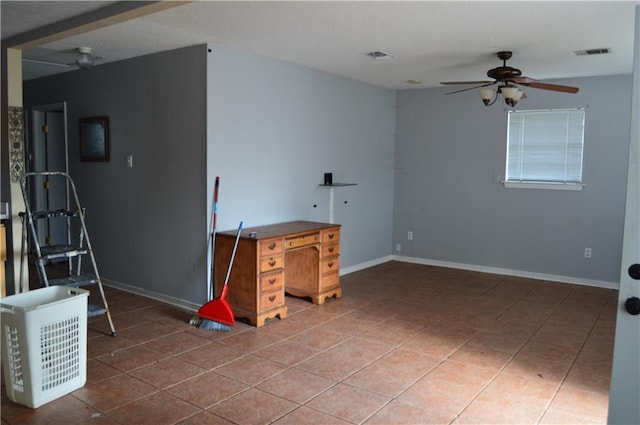 interior space featuring tile patterned flooring and ceiling fan